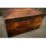 A Victorian rosewood sarcophagus tea caddy, hinged cover enclosing a pair of lidded compartments,