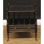 A late Victorian ebonised and parcel-gilt four-section Canterbury, turned supports, drawer to