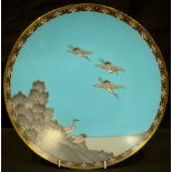 A Chinese cloisonne plate, decorated with cranes in flight, 30cm diameter