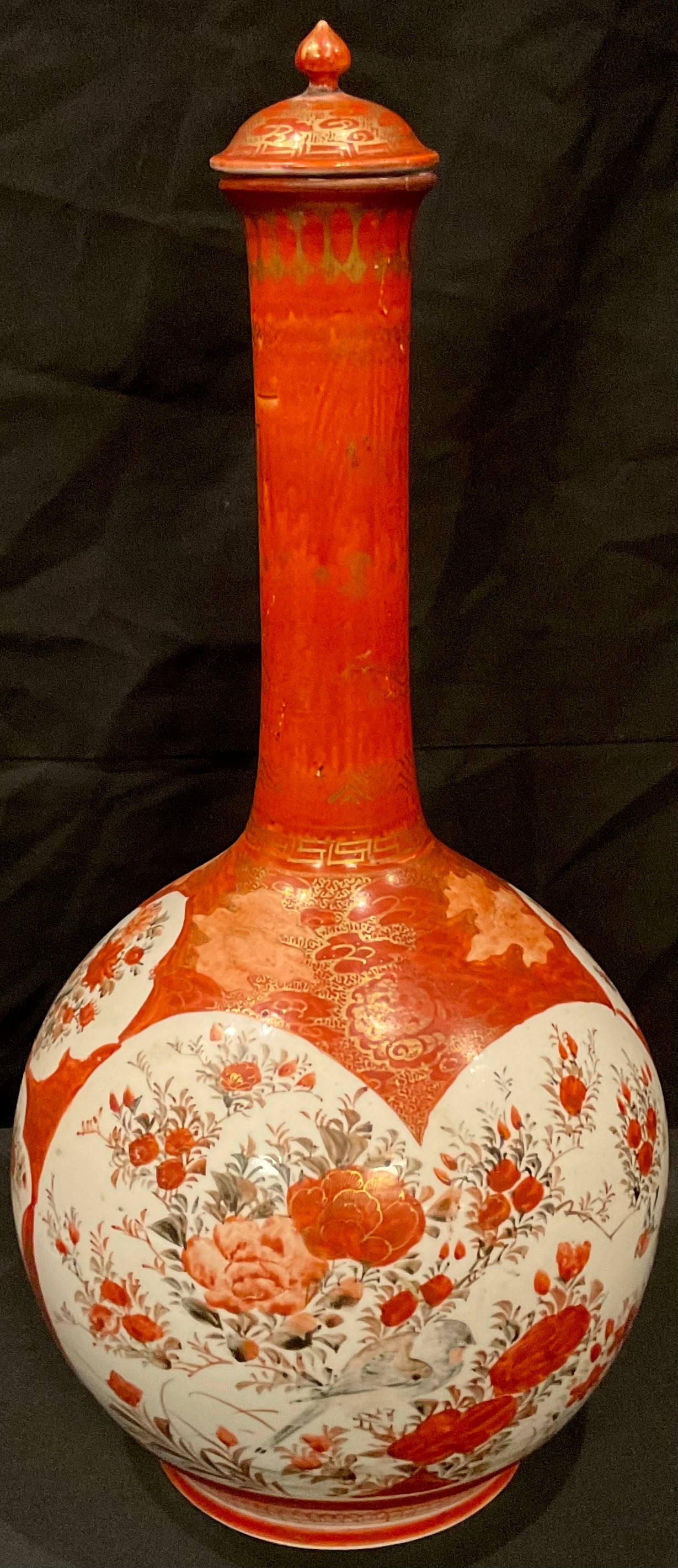 A Japanese Kutani bottle vase and cover, painted with birds perched amongst blossom, 39.5cm,