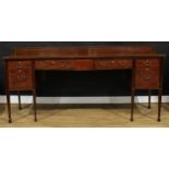 A large George III Revival mahogany serpentine serving table or sideboard, slightly oversailing