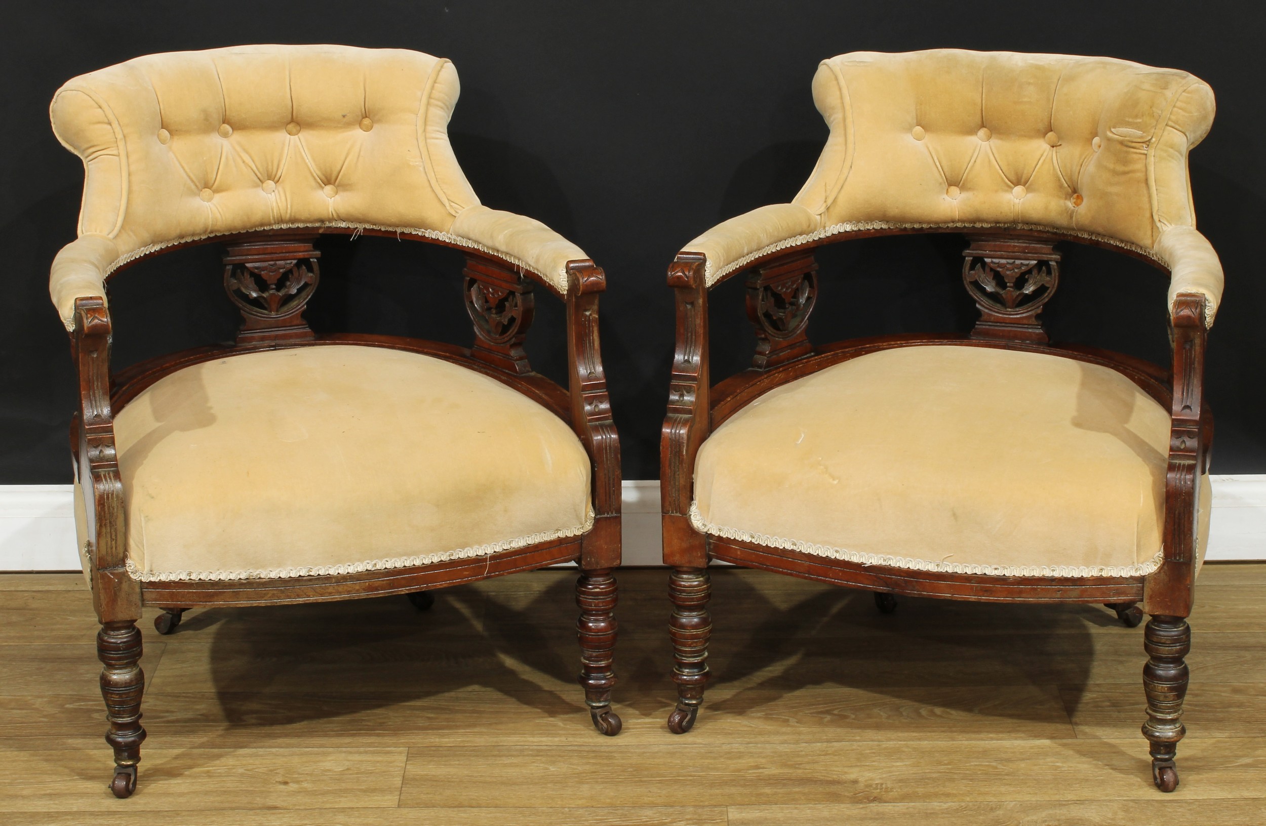 A pair of late Victorian/Edwardian tub-proportioned club elbow chairs, 73cm high, 61cm wide, the