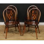 A set of four Ercol ?fleur-de-lis? dining chairs, 82cm high, 42.5cm wide, the seat 34cm deep (4)