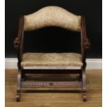A 19th century Continental softwood Savonarola type chair, the arms carved with grotesque masks,