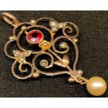A 9ct gold Art Nouveau pearl and garnet set pendant