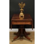 A Regency mahogany Pembroke table, rounded rectangular top with fall leaves above a single frieze