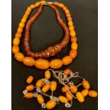 An amber bead necklace, another; loose beads