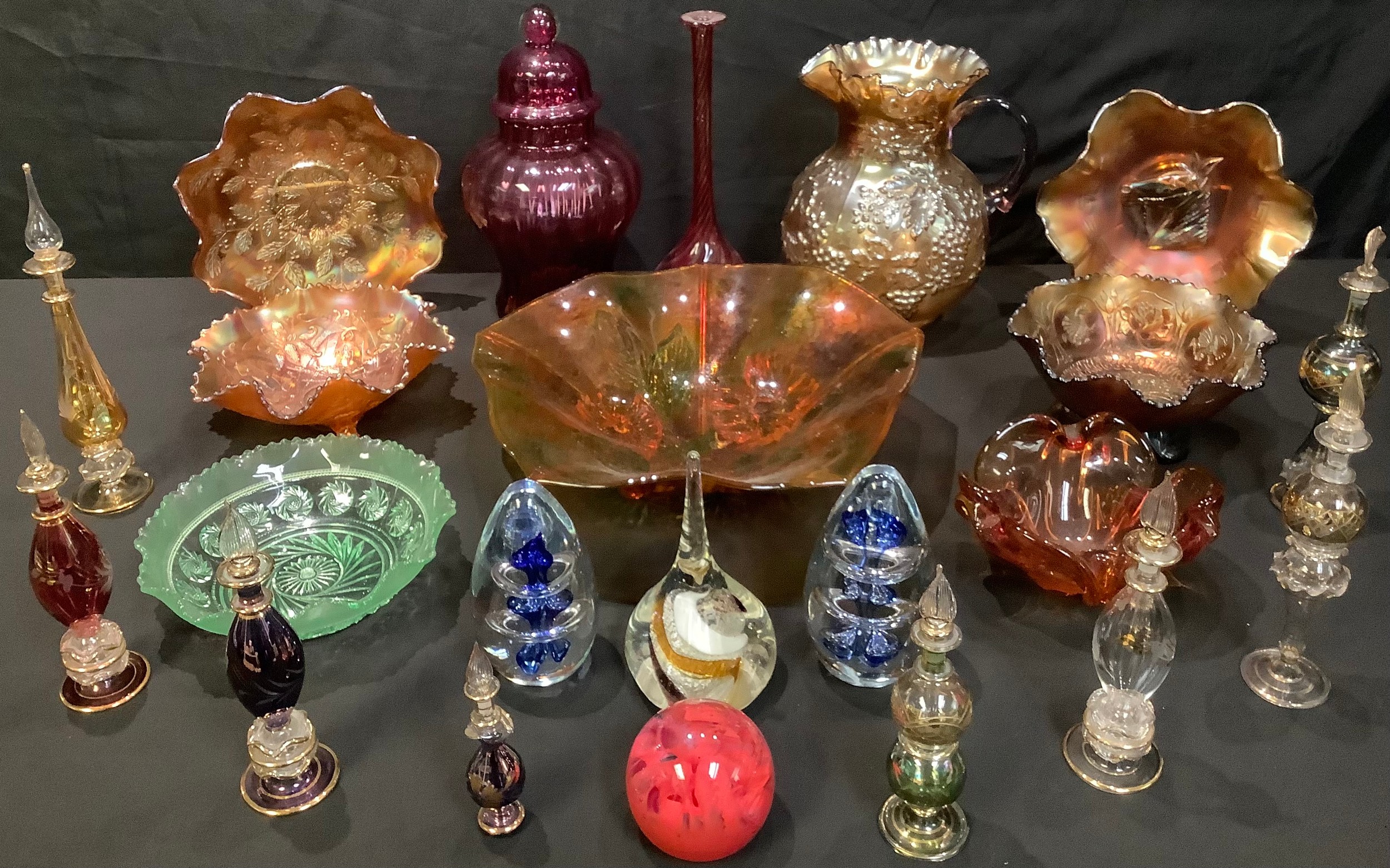 An Egyptian glass scent bottle with stopper; others; Carnival glass dishes; a cranberry style vase