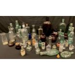 A collection of glass advertising bottles including Midland Hotel, Derby pumpkin whisky flask;