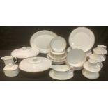 A Royal Doulton Gold Concord patter dinner service comprising a pair of vegetable dishes and covers,