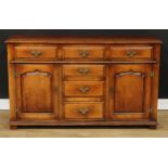 A George III style oak low dresser, possibly Titchmarsh & Goodwin, rectangular top above an