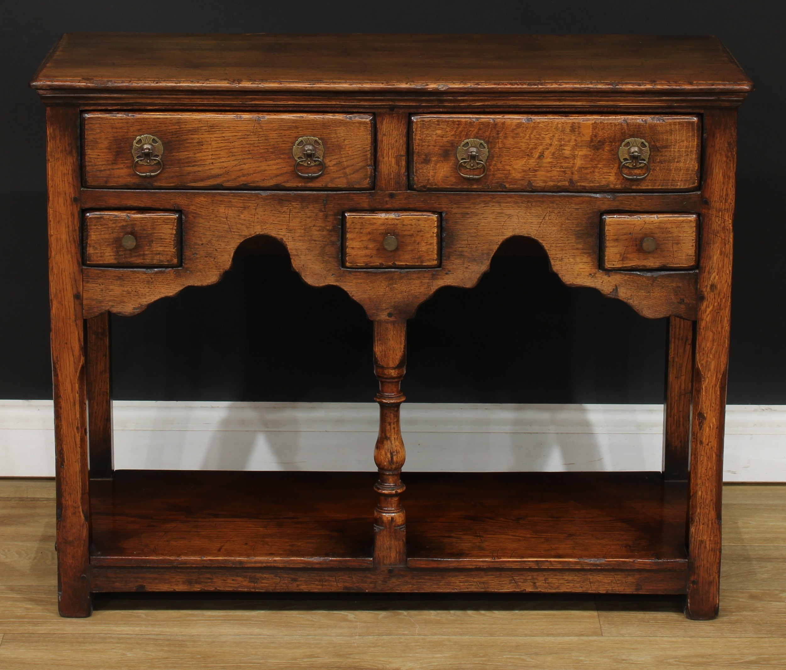 An oak low potboard dresser, possibly Titchmarsh & Goodwin, rectangular top above an arrangement