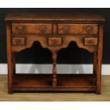 An oak low potboard dresser, possibly Titchmarsh & Goodwin, rectangular top above an arrangement