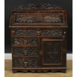 A late Victorian oak bureau, shaped half gallery above a fall front, an arrangement of drawers and a