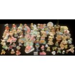 A collection of Cherished Teddies and other decorative moulded resin models and fairy figures; qty