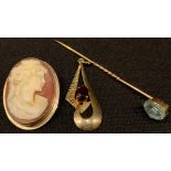 A 9ct gold and garnet pendant; a 9ct gold mounted shell cameo brooch/pendant, marked 375; a 9ct gold
