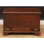 An 18th century oak mule chest, of small proportions, hinged top above three drawers, skirted