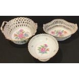 A Dresden two handled pierced openwork basket, applied with sprigs of flowers in relief, the