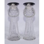 A pair of Edwardian silver mounted cut glass spill vases, each as a thistle, marks rubbed,