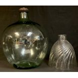 A large green glass carboy with seal cover, 50cm ; a clear glass spirally fluted cloche, 30cm (2)