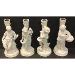 A set of four Victorian Copeland Parian figural candlesticks, The Four Seasons (lacking branches)