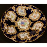 A Meissen shaped circular cabinet plate, printed with summer flowers on a cobalt blue ground,