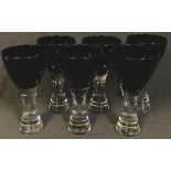 Set of six contemporary wine glasses, black glass bowls supported on heavy clear glass stems, each