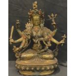 A gilt metal model of a Deity, inset with coral and turquoise, 21.5cm high