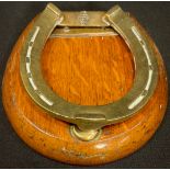 A late Victorian oak and brass novelty letter clip, of equestrian interest as a horse shoe, 11cm