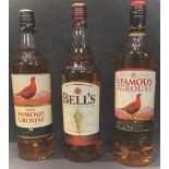 A bottle of The Famous Grouse blended Scotch whisky, 1litre; another, 1litre; a bottle of Bell's