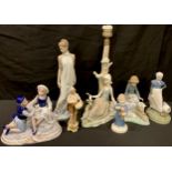 A Lladro porcelain table lamp, Girl with Dove; a Nao figure, Girl with Rabbits; another, Elegant