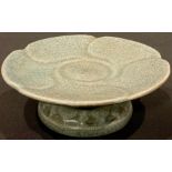 A Chinese celadon pedestal dish, cracked glazed, 14cm diameter