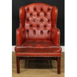 An office reception Chesterfield wingback armchair, deep-button back and seat, 98cm high, 70cm wide,