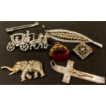 A stone set leaf brooch; a swivel fob; a mother of pearl crucifix; brooches