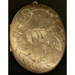 A 9ct gold oval locket, chased and engraved with leafy foliage, 6cm, marked 375, 22g
