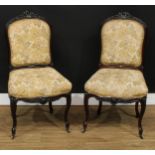 A pair of 19th century rosewood side chairs, stuffed-over upholstery, carved throughout with