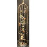 A tall decorative floor standing novelty birdcage, the interior applied with enamelled bird