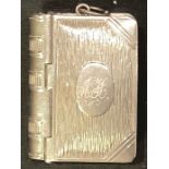 A Victorian novelty combination vesta and stamp case, modelled as a book