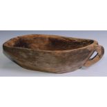 A Mediterranean hand-carved dough bowl, 18.5cm high, 70cm wide over handle, 52cm deep