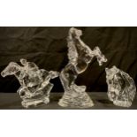 A Waterford Crystal clear glass model of a rearing horse, 23cm, engraved mark; two others, jockey on