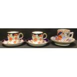 A pair of Royal Crown Derby coffee cans and saucers, c.1925; another Imari pattern coffee can and