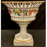 A Dresden pierced reticulated pedestal basket, applied with floral garlands in relief, the