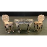 A silver miniature French style oval table and confirming chairs, the able 45mm wide, London 1974,