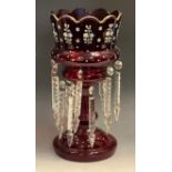 A late Victorian ruby glass lustre, pained with stylised flowers, two rows of clear glass lustres,