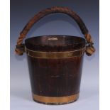 A coopered oak fireside fuel or peat bucket, leather covered rope handle, 30.5cm high, the top 30.