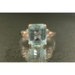 A diamond and aquamarine ring, rectangular octagonal cut aquamarine, measuring, 9.7mm x 8mm x 4.7mm,