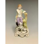 A German figure, of a boy and his dog, standing holding his hat, a sheep at his side, scroll base,