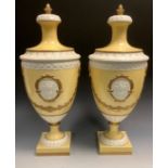 A pair of Italian urns and covers, in relief with oval cartouches, in relief with urns and