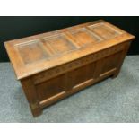 A 18th century oak blanket box, three panelled front, the interior with candle box, 54cm high, 109cm