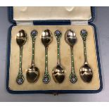 A George V silver coffee spoons, the stems enamelled with blue flowerheads, Birmingham 1933, cased